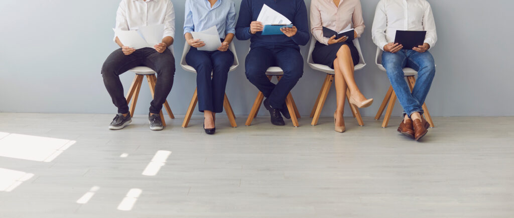 Group of people waiting in line for job interview